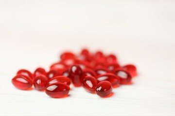 Krill oil gelatin capsules set on a white wooden background .omega fatty acids.Natural supplements and vitamin