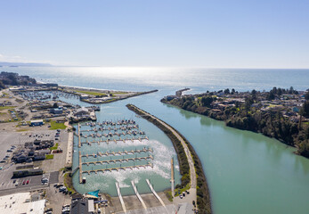 Brookings Oregon marina on sunny day with ocean view, aerial.