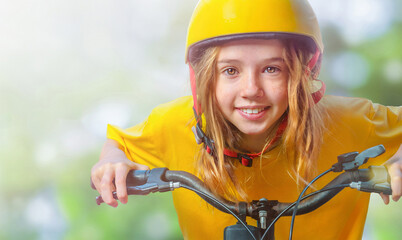 Portrait of the girl on the bicycle and yellow helmet