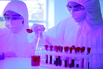 Scientists working with samples in laboratory