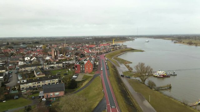 Rotating drone revealing Ameide dutch city at Lek river-banks