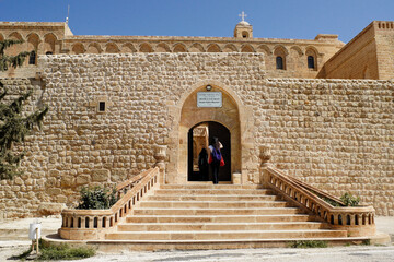 Stone steps lead up to the arched portal into the walled Deyrulzafaran Monastery in Mardin, Eastern Anatolia, Turkey