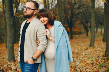 Elegant couple spend time in a autumn park