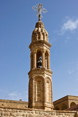 Fototapeta na wymiar The carved stone bell tower of Deyrulumur Monastery near Midyat, Eastern Anatolia, Turkey