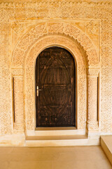 Ornate carved stone doorway and carved wood door at Deyrulumur Monastery, Midyat, Eastern Anatolia, Turkey