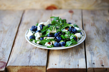 The best salad with blueberries, cheese and arugula.