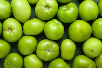 Many green tomatoes as background, closeup