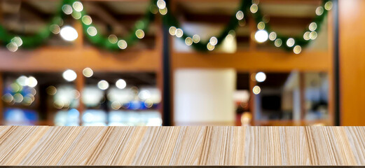 Wooden table in front of blurred background and round bokeh, storefront in a shopping mall.