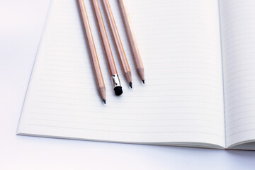 Pencils on notebooks or paper on white background