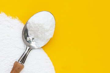 Baking soda on yellow background.