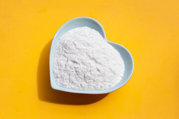 Baking soda on yellow background.