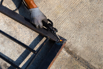 Iron gate repair, Worker hand welding steel