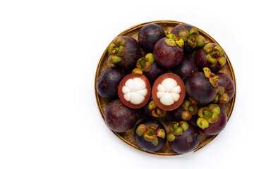 Mangosteen in round basket on white background. Top view