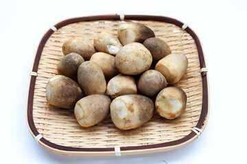 Fototapeta na wymiar Straw mushroom in bamboo basket on white background.