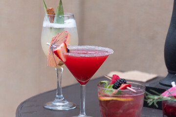 Fresh strawberry cocktail. Fresh summer cocktail with strawberry and ice cubes. Glass of strawberry soda drink on daylight background