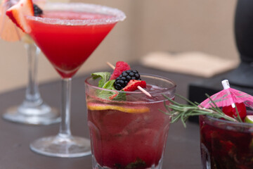 Fresh strawberry cocktail. Fresh summer cocktail with strawberry and ice cubes. Glass of strawberry soda drink on daylight background
