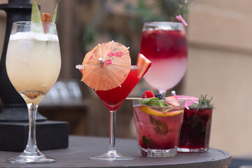 Fresh strawberry cocktail. Fresh summer cocktail with strawberry and ice cubes. Glass of strawberry soda drink on daylight background