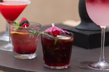 Fresh strawberry cocktail. Fresh summer cocktail with strawberry and ice cubes. Glass of strawberry soda drink on daylight background