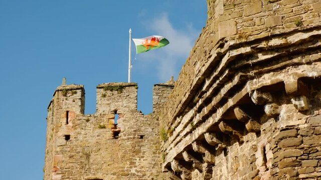 The Welsh flag flies at Conwy Castle, in North Wales, UK, built by Edward I, during his conquest of Wales, between 1283 and 1289
