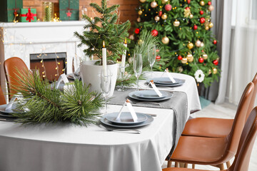 Dining table with beautiful setting in living room decorated for Christmas eve