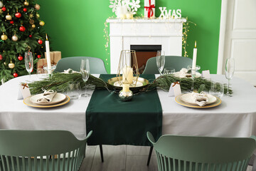 Dining table with beautiful setting in living room decorated for Christmas eve