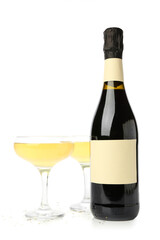 Glasses and bottle of champagne on white background