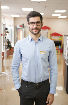 Male Optical Shop Assistant Posing For Camera