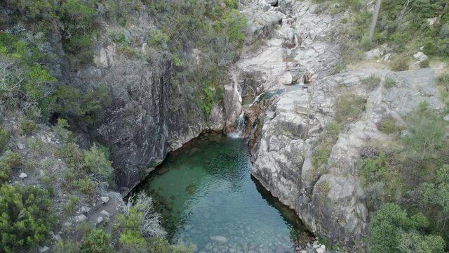 Natural pool at Cascatas de Fecha de Barjas in Peneda-Geres National park, Portugal. Aerial top down orbit