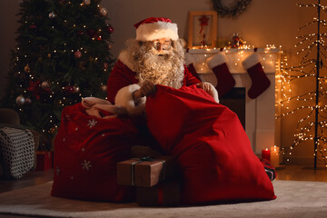 Santa Claus with bag in room at Christmas night