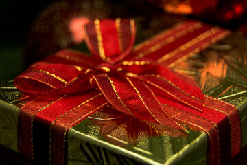 Present gift box with red ribbon.
