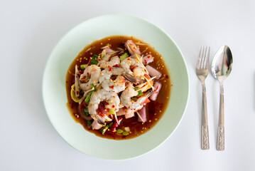 Spicy sea food  papaya salad “somtum“ Thai traditional. food on White background