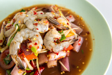 Spicy sea food  papaya salad “somtum“ Thai traditional. food on White background