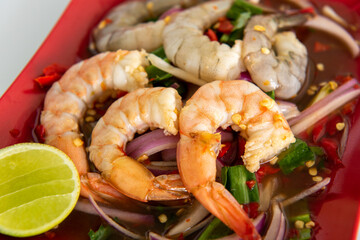 Spicy sea food  papaya salad “somtum“ Thai traditional. food on White background
