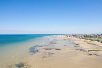 The fine sandy beach of Juno beach in Bernieres sur Mer in Europe, France, Normandy, Arromanches les Bains, in summer, on a sunny day.