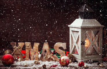 Christmas Lantern on snowy table with festive decoration.