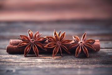 Star anise and cinnamon stick on wooden background