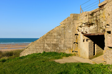 Fototapeta na wymiar The impacts on the WN62 bunker at Omaha beach in Europe, in France, in Normandy, towards Arromanches, in Colleville, in the spring, on a sunny day.