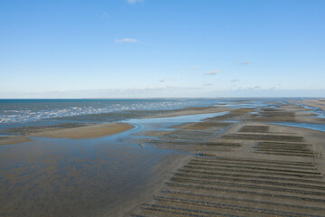 Obraz premium The panoramic view of the oyster park from Utah Beach in Europe, France, Normandy, towards Carentan, in spring, on a sunny day.