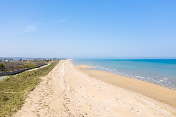 Fototapeta na wymiar The long beach of Utah Beach in Europe, France, Normandy, Manche, in spring on a sunny day.