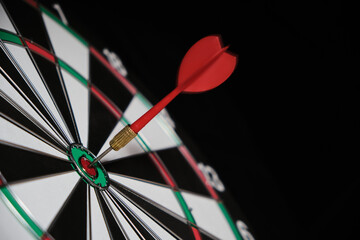 Dartboard with darts hitting exactly on target.