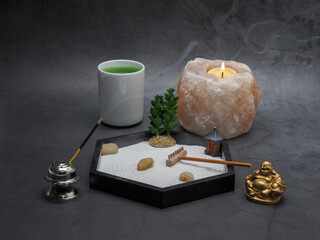 Health and Wellness Concept ith Zen Garden Salt Candle and Green Tea with incense and Buddha