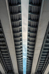 Fototapeta na wymiar View of the bridge from below. Symmetry in the engineering structure of the bridge