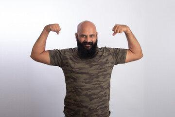 Naklejka premium happy Indian Healthy middle aged man showing his arms and biceps