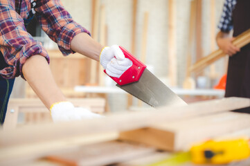 young carpenter Asian man, wooden maker craftsman working with a industry carpentry tool workshop