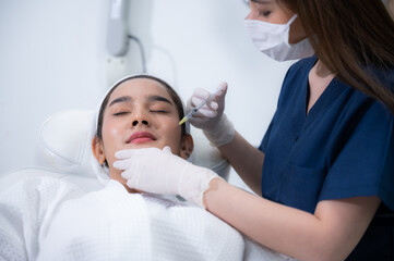 Fototapeta na wymiar young Asian woman making cosmetology treatment skin injection, Mesotherapy of face beauty care