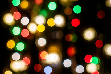 Obraz premium black abstract background with multicolored lights with bokeh in blur