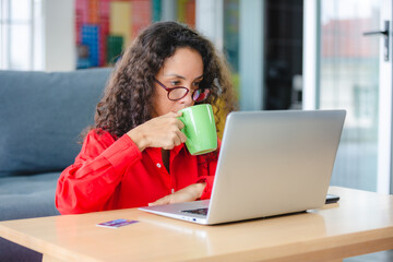 African American business freelance woman working at home with online communication using laptop