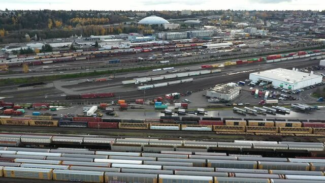 BNSF Tacoma Rail Yard With Trains Cars And The Tacoma Dome In The Background