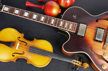 Fototapeta na wymiar Jazz electric guitar and violin on a black background.