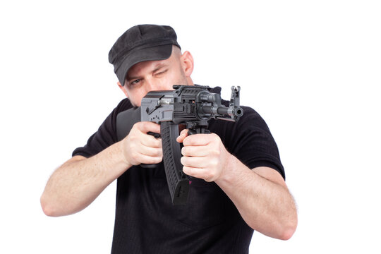 Man pointing AK-47 machine gun, isolated on white. Focus on the gun